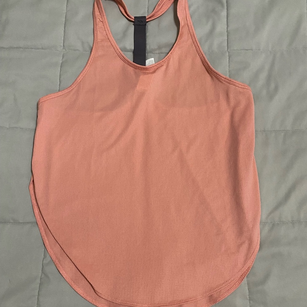 BNWOT Fabletics workout tank top. Light coral/Mauve color. High slits on sides.